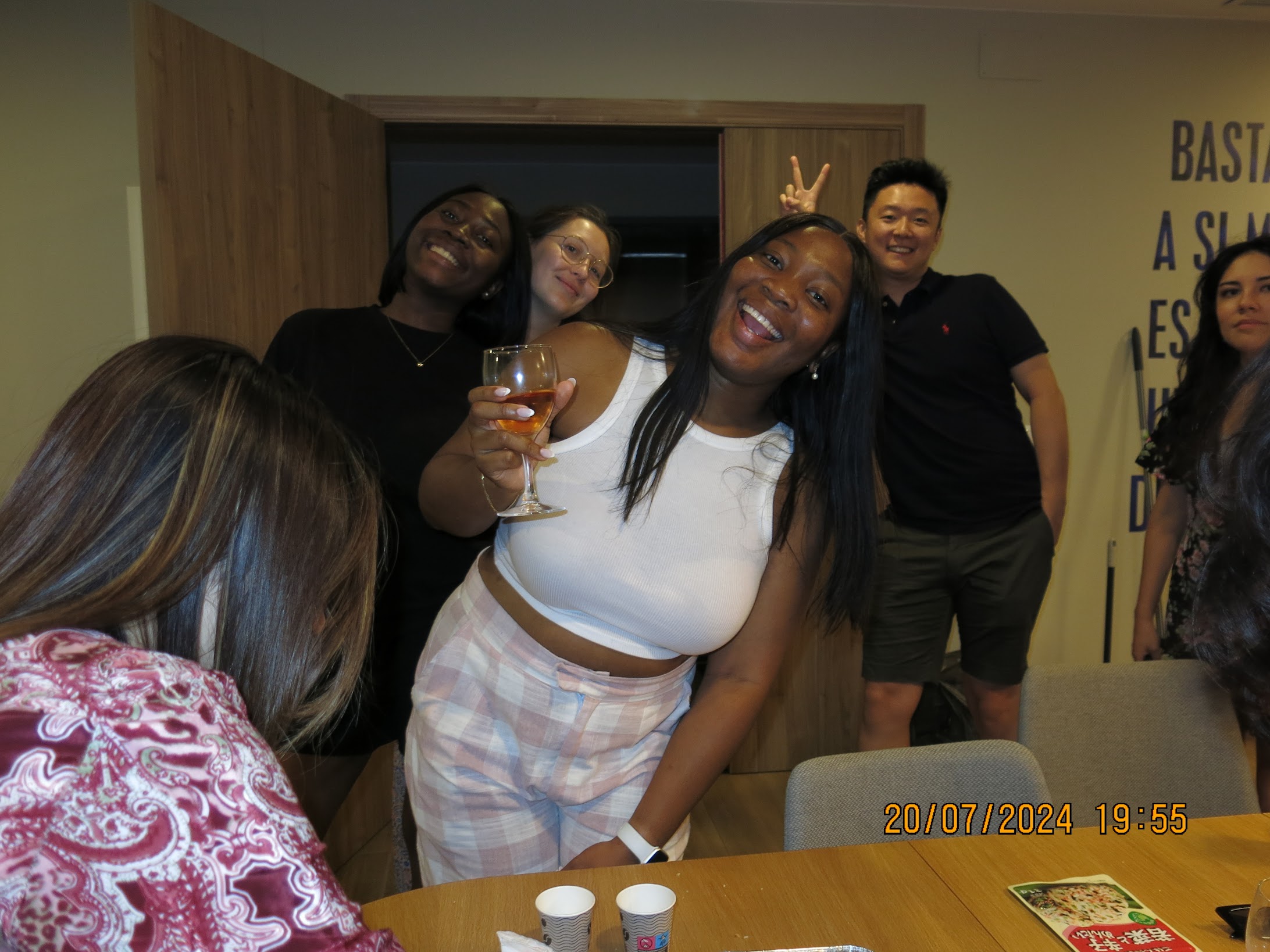 Friends laughing together with drinks raised