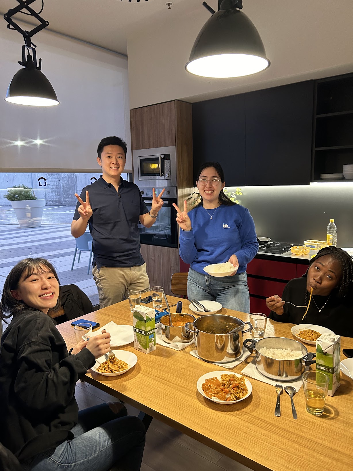 Friends sharing a potluck meal together in the kitchen
